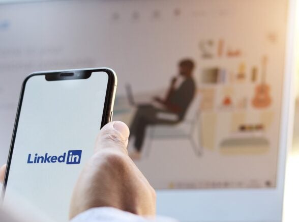 LinkedIn on phone and on background
