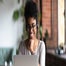 Worker on laptop smiling in office
