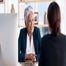 Manager over desk speaking to employee