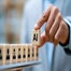 AI on wooden cubes with hand over candidates