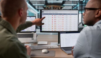 Employees measuring performance on laptop