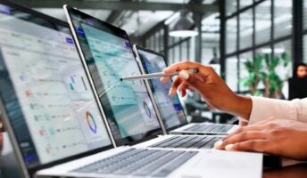 Leader reviewing data on laptop screens