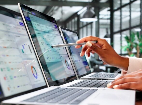 Leader reviewing data on laptop screens