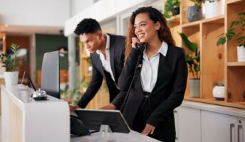 Hotel receptionist using telephone