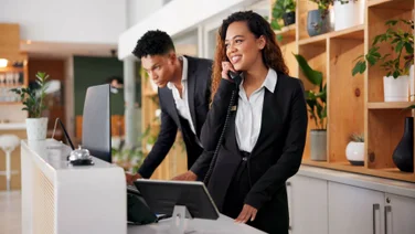 Hotel receptionist using telephone