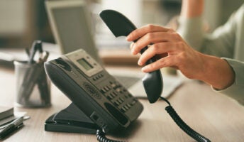 Person picking up office phone