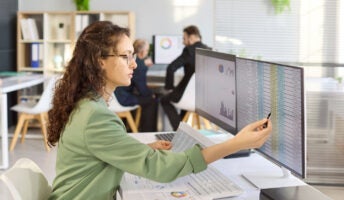 Payroll professional working on computer
