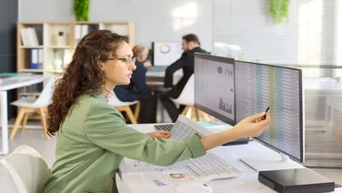 Payroll professional working on computer