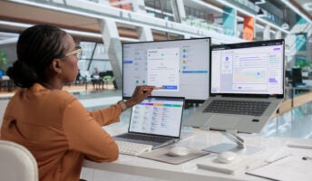 HR professional working with 3 monitors