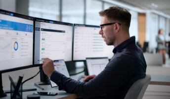 HR professional monitoring employee performance on a computer screen