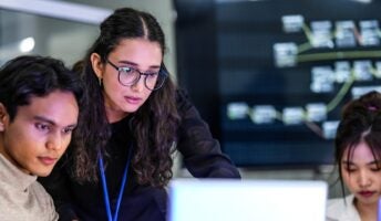 Workers around laptop technology
