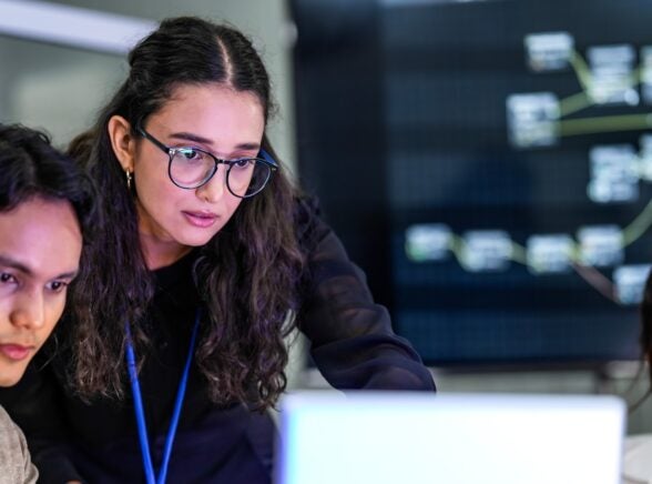 Workers around laptop technology
