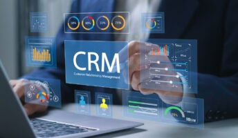 Office worker using CRM platform on laptop