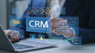 Office worker using CRM platform on laptop