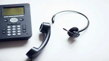 VoIP deskphone and headset on desk