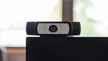 Webcam mounted on desktop screen