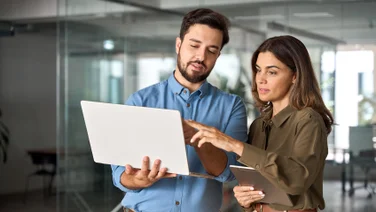 Colleagues working together on a laptop and tablet