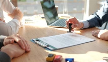 Hand stamping contract on desk
