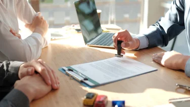 Hand stamping contract on desk