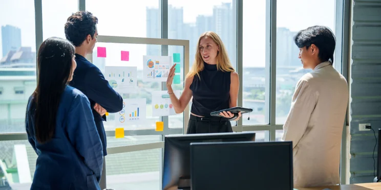 Team working together over whiteboard
